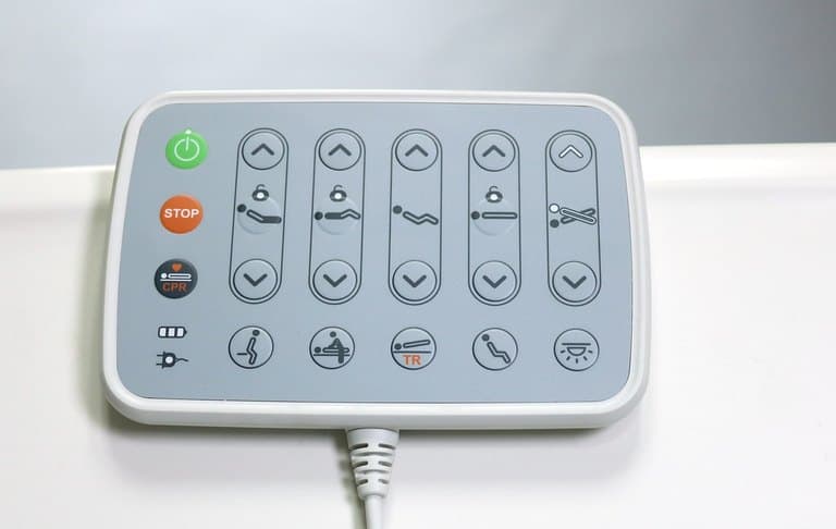 F5 Medical Bed, close-up of wired control pad with power, STOP, CPR and section position buttons