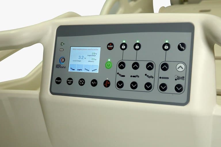 Santron Pro ICU Bed, close-up of rail control panel with weighing display and position controls