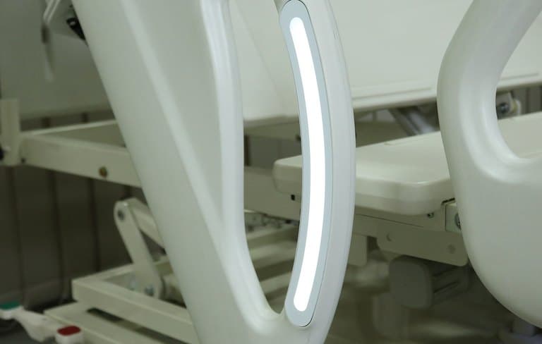 Santron Hospital Bed, close-up of the lit LED strip on the side-rail handle