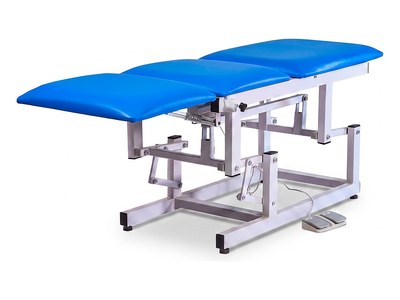 Three-Section Electric Examination Couch, blue upholstery, sections level, foot switch on floor, three-quarter studio view