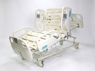 F5 Medical Bed, three-quarter view with backrest and knee section raised, bare deck, rails up