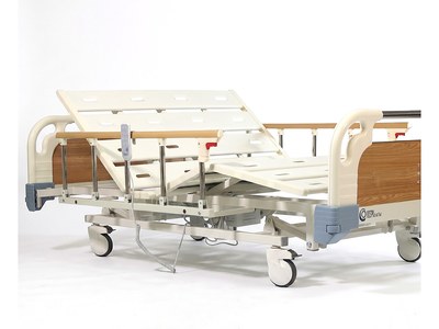 Three-Function Bariatric Bed (Wide), backrest and knee section raised, side rails up, handset on rail, foot-end view