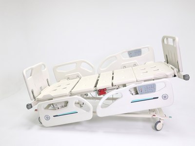 Santron Hospital Bed, side view with platform tilted, rails up, white studio