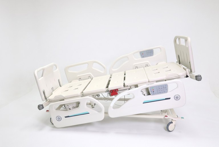 Santron Hospital Bed, side view with platform tilted, rails up, white studio