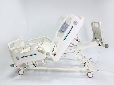 Santron Hospital Bed, side view with backrest raised upright, rail control panel visible, white studio